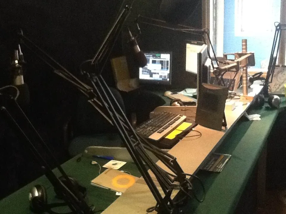 A radio on-air position with console, microphone and playout screens